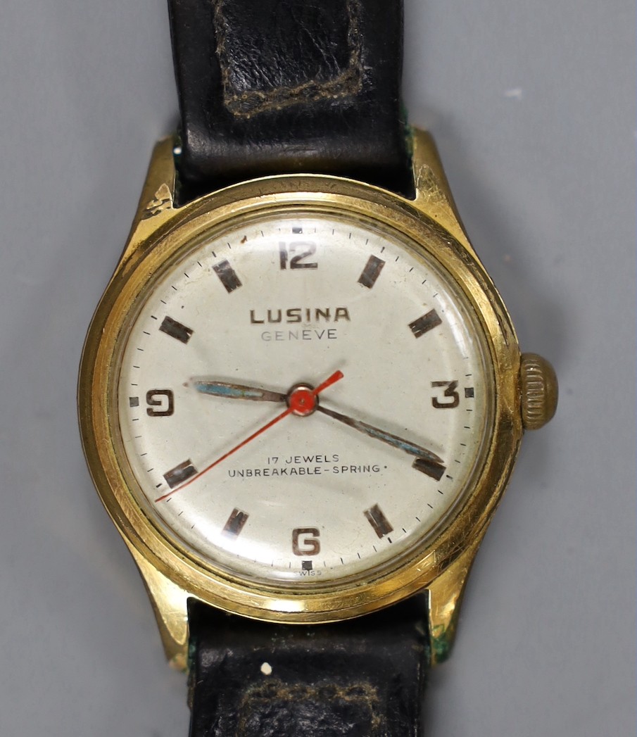 A steel and gold plated boy's size Lusina manual wind wrist watch, on leather strap.